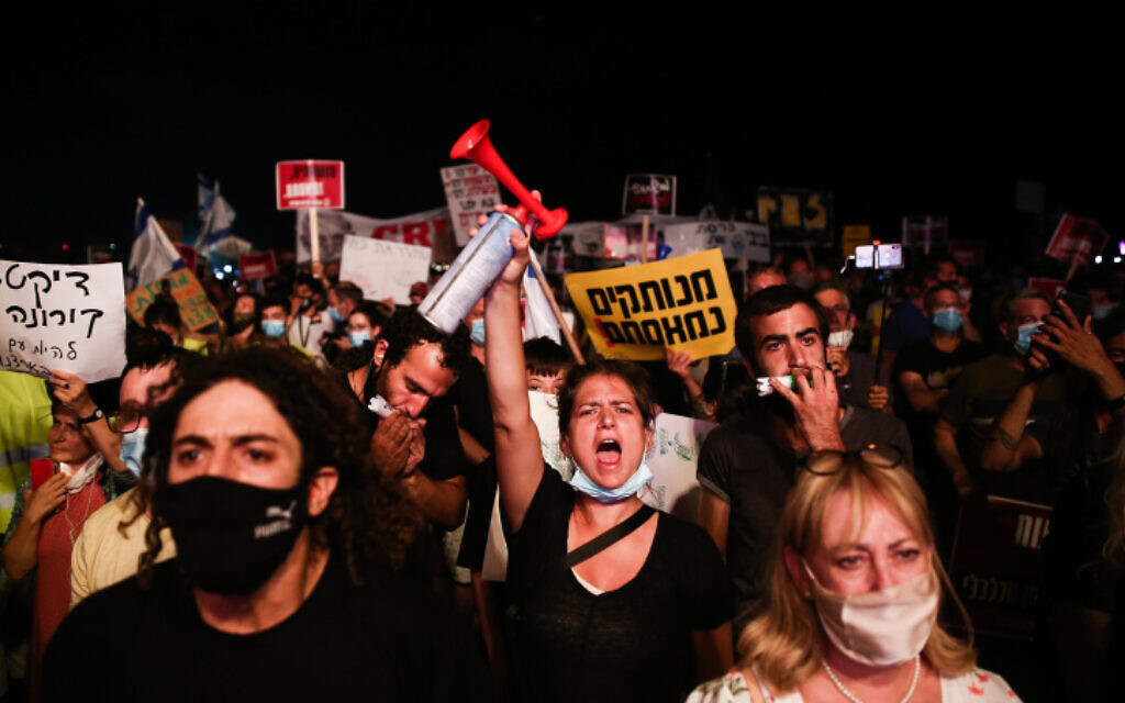Israelis protest against the government's latest coronavirus restrictions in Tel Aviv on July 18, 2020 (Miriam Alster/Flash90)
