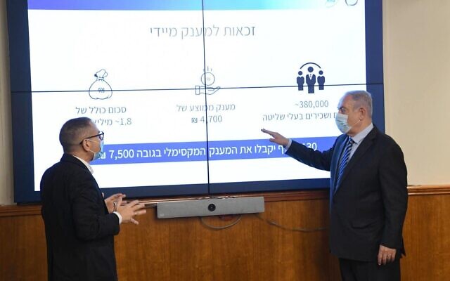 Prime Minister Benjamin Netanyahu (R) discusses his virus stimulus package with Israel Tax Authority Director Aran Yaakov at the Prime Minister's Office in Jerusalem on July 15, 2020. (Amos Ben Gershom/GPO)