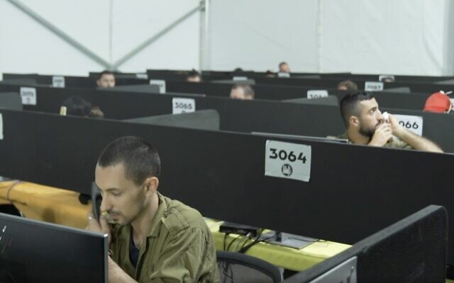 Illustrative: In a video released by the Israel Defense Forces on July 29, 2020, soldiers man the phones at the IDF Home Front Command's headquarters during a visit by coronavirus czar Prof. Ronni Gamzu. (Screen capture: Israel Defense Forces)