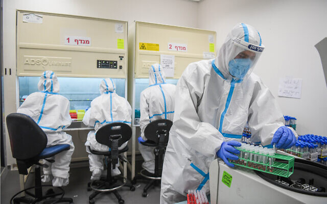 Illustrative: Technicians carry out a diagnostic test for coronavirus in a lab at a Meuhedet Health Services branch in Lod, July 2, 2020. (Yossi Zeliger/Flash90)