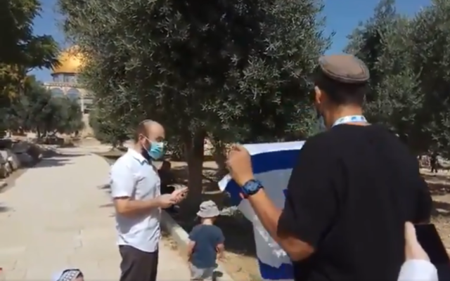 A Jewish activist waves an Israeli flag at the Temple Mount compound on Tisha B'Av, July 30, 2020. (Screen capture: Twitter)