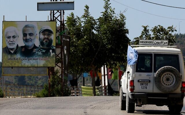 A UNIFIL patrol drives past a billboard showing the faces of slain Iraqi Popular Mobilization Forces commander Abu Mahdi al-Muhandis, Iranian Quds Force commander Qassem Soleimani and Hezbollah military commander Imad Mughniyeh, in the southern Lebanese village of Adaisseh on the border with Israel, August 26, 2020. (Mahmoud Zayyat/AFP)