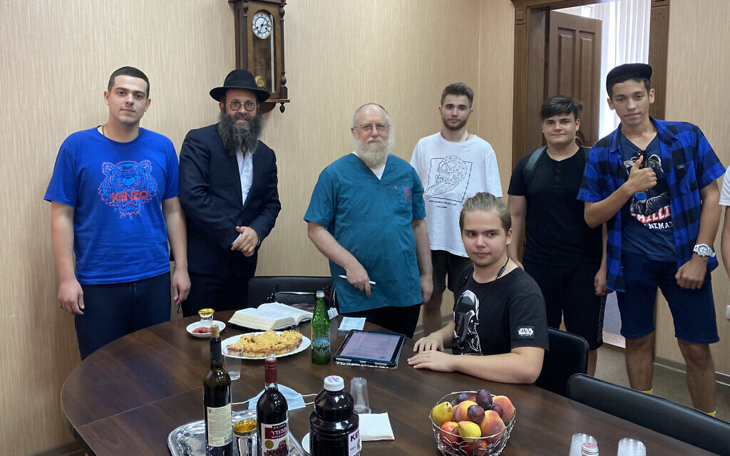 Rabbi Chaim Danzinger, left, introduces Dr. Yeshaya Shafit, second from left, to Jews awaiting circumcision at the synagogue of Rostov-on-Don in Russia, July 27, 2020. (Courtesy of the Jewish Community of Rostov/ via JTA)