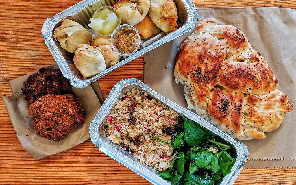 A takeout order of knishes, challah, couscous and cookies. (Pink Peacock/ vis JTA)