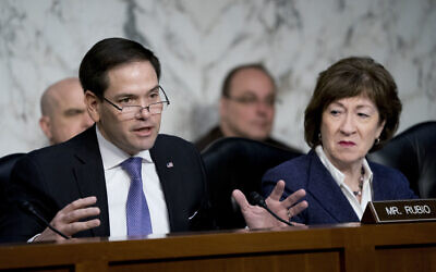 Sen. Marco Rubio, R-Fla., left, accompanied by Sen. Susan Collins, R-Maine, right, speaks before a Senate Intelligence Committee hearing on election security on Capitol Hill in Washington, March 21, 2018. (AP Photo/Andrew Harnik)