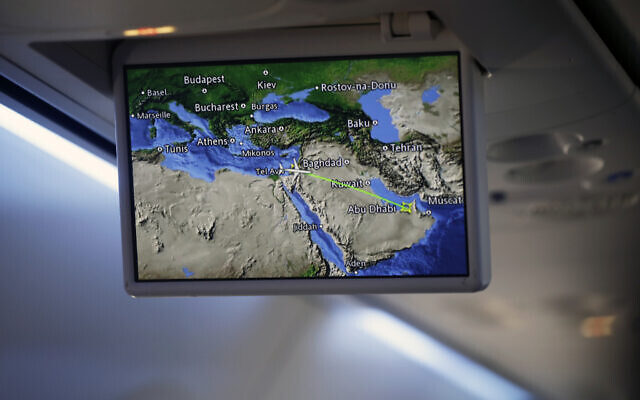 An overhead screen displays a map showing the flight route of an El Al plane from Israel en route to Abu Dhabi, United Arab Emirates, Monday, Aug. 31, 2020. (Nir Elias/Pool Photo via AP)