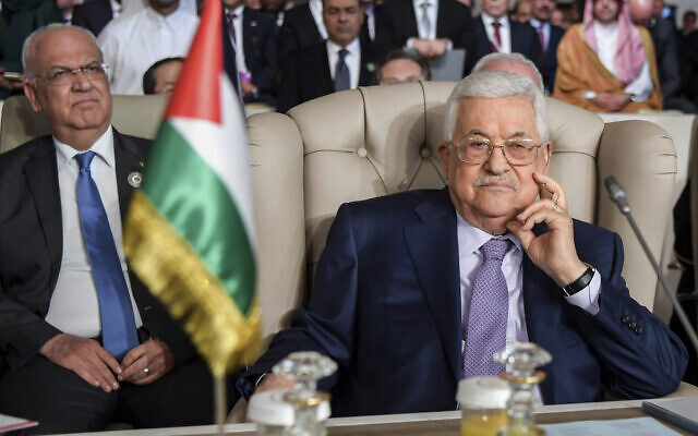 Palestinian Authority President Mahmoud Abbas, right, and secretary general of the Palestinian Liberation Organization, Saeb Erekat attend the the 30th Arab Summit in Tunis, Tunisia, Aughust 16, 2020. (Fethi Belaid/ Pool photo via AP)