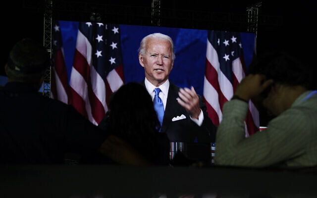Supporters watch the program outside the venue where Democratic presidential candidate former Vice President Joe Biden is speaking, during the final day of the Democratic National Convention, Thursday, Aug. 20, 2020, at the Chase Center in Wilmington, Del. (AP Photo/Carolyn Kaster)