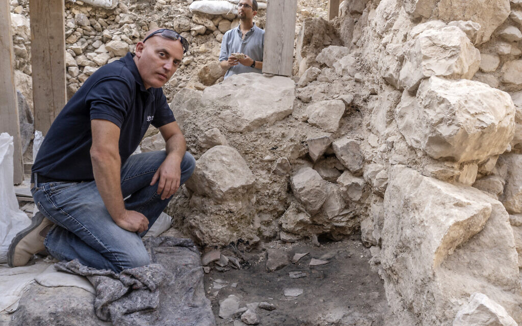 Dr. Yiftah Shalev next to the smashed First Temple pottery vessels that were found at the site with remnants of the 586 BCE destruction of Jerusalem by the Babylonians at excavations in the City of David Park in Jerusalem.(Shai Halevi/Israel Antiquities Authority)