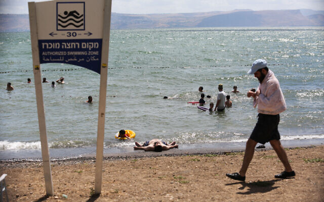 People enjoy the beaches of the Sea of Galilee in northern Israel, June 19, 2020. (David Cohen/Flash90)