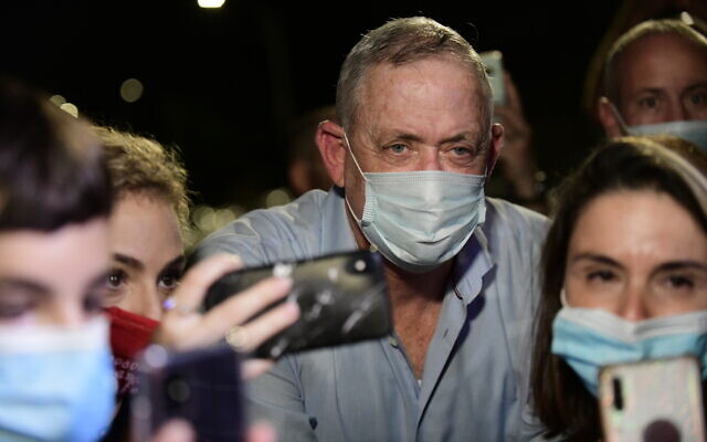 Defense Minister Benny Gantz speaks to the media outside his home in Rosh Haayin, during a protest by Israelis from the culture and art industry demanding the restarting of performances amid the COVID-19 pandemic, on August 9, 2020. (Tomer Neuberg/Flash90)