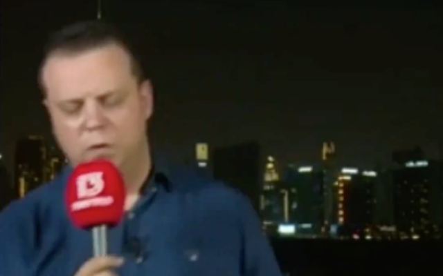 Channel 13's Doron Herman faints on air while reporting from Dubai on August 16, 2020. (Screen capture/ Twitter)