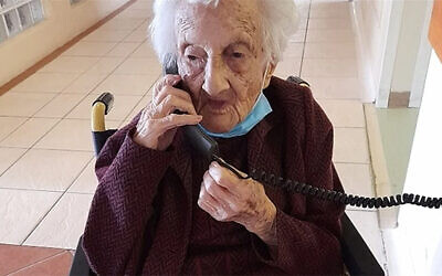 Rosalie Wolpe speaks to a relative on the phone on her 111th birthday at a retirement home in Cape Town, South Africa on August 25, 2020. (David Wolpe via JTA)