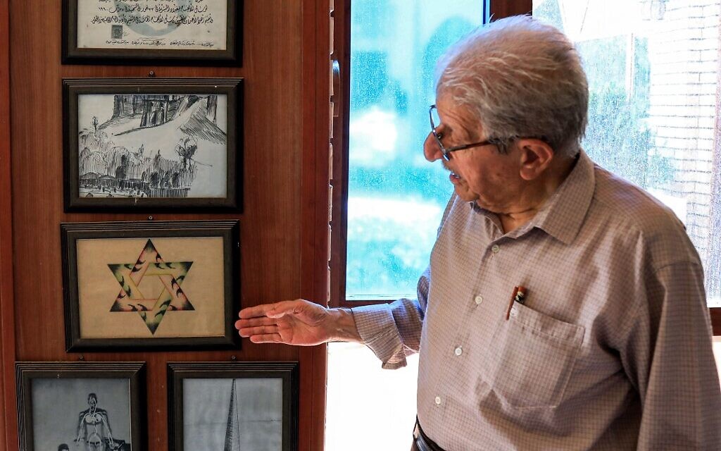 Omar Farhadi, an elderly Iraqi Kurd points to a frame showing a stylized hexagram, or a Star of David, hanging in a room dedicated to famous Jewish Kurdish art teacher and painter Daniel Kassab, at the Museum of Education in Erbil's oldest primary school, in the capital of the autonomous Kurdish region of northern Iraq, on July 5, 2020. (SAFIN HAMED / AFP)