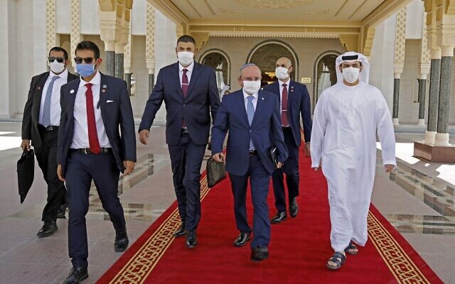 he head of Israel’s National Security Council, Meir Ben-Shabbat (2nd-R), wearing a protective mask, makes his way to board the plane as he prepares to leave Abu Dhabi on September 1, 2020, at the end of an unprecedented visit on normalizing Israel-UAE relations. (NIR ELIAS / POOL / AFP)