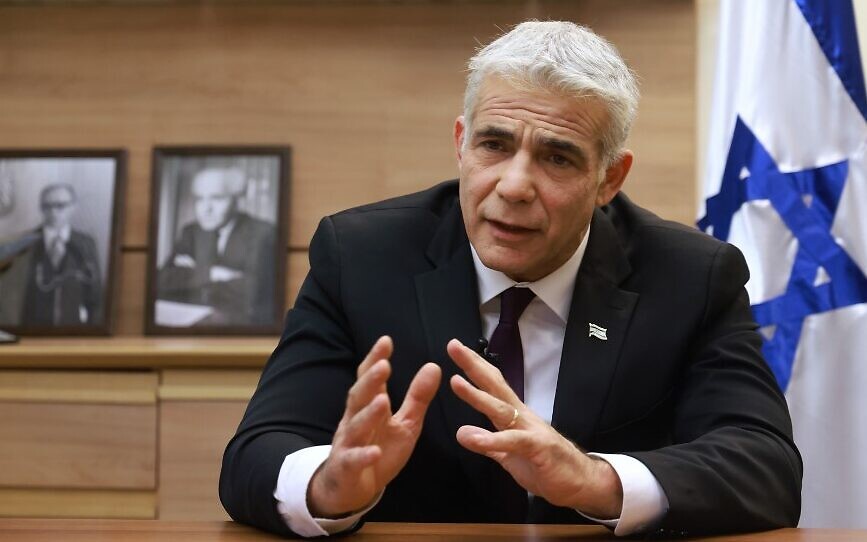 Foreign Minister Yair Lapid during an interview at his office (Emmanuel Dunand/AFP/File)