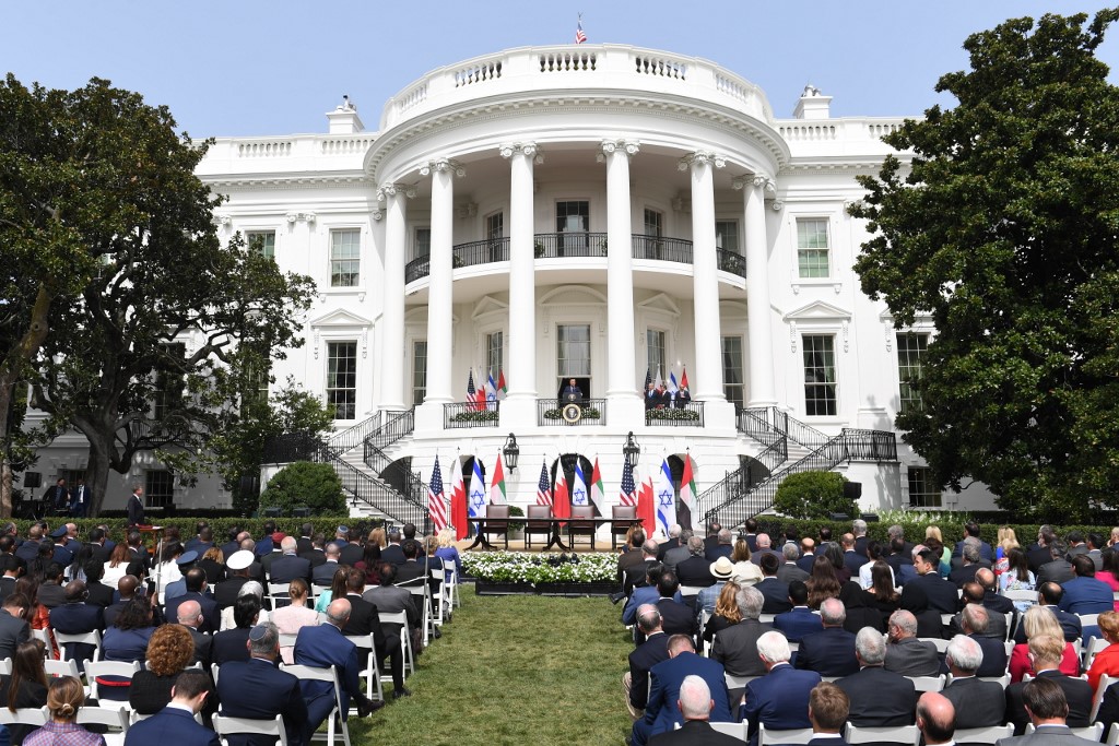 An audience watches as US President Donald Trump speaks from the Truman Balcony at the White House during the signing ceremony of the Abraham Accords where the countries of Bahrain and the United Arab Emirates normalize ties with Israel, on the South Lawn of the White House in Washington, DC, September 15, 2020 (SAUL LOEB / AFP)
