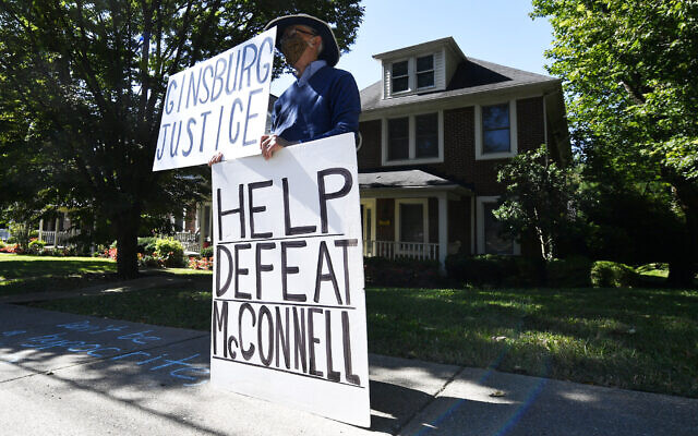 Protesters rally outside the house of Senate Majority Leader Mitch McConnell in Louisville, Kentucky, September 19, 2020. (AP Photo/Timothy D. Easley)
