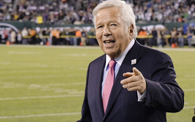 In this Oct. 21, 2019, file photo, New England Patriots owner Robert Kraft points to fans as his team warms up before an NFL football game against the New York Jets in East Rutherford, N.J.  (AP Photo/Bill Kostroun, File)