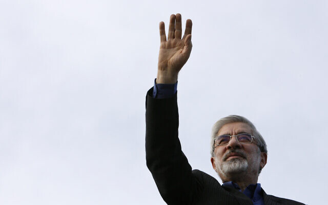 Mir Hossein Mousavi waves to his supporters as he arrives at a campaign gathering in downtown Tehran, Iran, June 8, 2009. (AP Photo/Vahid Salemi)