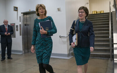 Republican Senator Lisa Murkowski of Alaska left, and Senator Susan Collins of Maine, walk together following a vote at the Capitol in Washington, February 12, 2020. (AP Photo/J. Scott Applewhite)