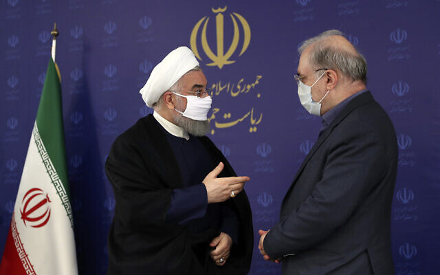 In this photo released by the official website of the office of the Iranian Presidency, President Hassan Rouhani, left, talks with his Minister of Health and Medical Education Saeed Namaki during a meeting in Tehran, Iran, Saturday, July 4, 2020. (Iranian Presidency Office via AP)