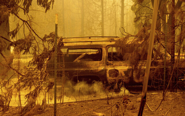 A scorched car rests in a clearing following the Bear Fire in Butte County, California, Sept. 9, 2020 (AP Photo/Noah Berger)