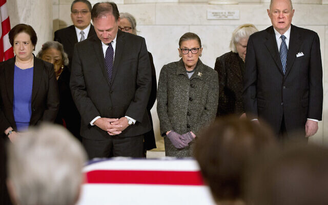 FILE: Supreme Court Justices, from left, Elena Kagan, Samuel Anthony Alito, Jr., Ruth Bader Ginsburg, and Anthony Kennedy participate in prayers at a private ceremony in the Great Hall of the Supreme Court in Washington, Friday, Feb. 19, 2016, where late Supreme Court Justice Antonin Scalia lies in repose. (AP Photo/Jacquelyn Martin, Pool)
