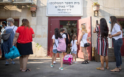 First grade students arrive to their first day of school at Jerusalem's Tali Geulim school on September 1, 2020 (Courtesy Noam Revkin Fenton/Flash 90)