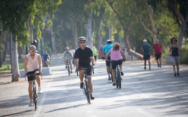 Bicylcists ride their bikes in a park in Tel Aviv, on September 20, 2020 (Miriam Alster/Flash90)
