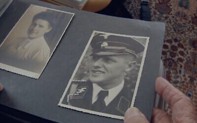 Screen capture from the Holocaust documentary film 'Final Account' of a former Nazi member of the SS looking at photographs. (video screenshot)