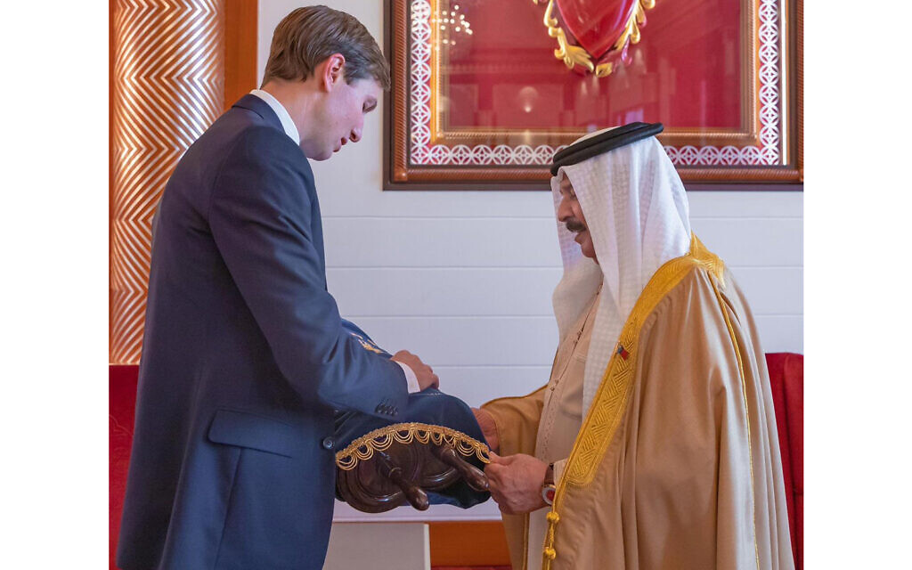 White House senior adviser Jared Kushner (left) presents a Torah scroll to Bahrain's king, Hamad bin Isa Al Khalifa, while visiting the Gulf state in early September, 2020. (Twitter/Avi Berkowitz)