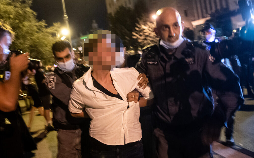 Police officers arrest a man who allegedly tried to run over protesters during a protest against Prime Minister Benjamin Netanyahu outside his official residence in Jerusalem, September 20, 2020. (Yonatan Sindel/Flash90)