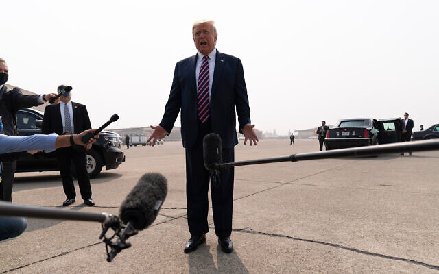 US President Donald Trump speaks to reporters as he arrives at Sacramento McClellan Airport, in McClellan Park, California, September 14, 2020. (AP Photo/Andrew Harnik)