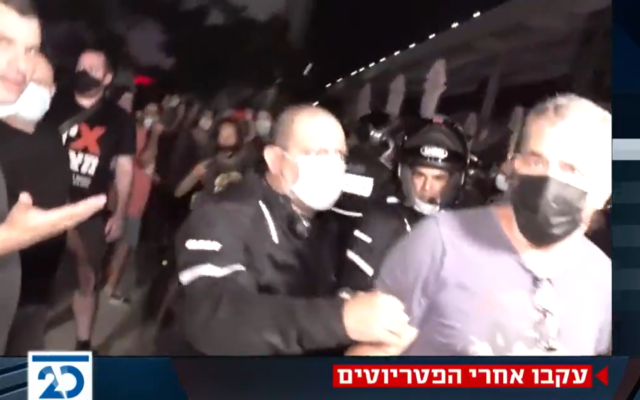 Anti-Netanyahu protesters disrupt a broadcast by Channel 20 at Habima Square in Tel Aviv, September 29, 2020. (Screenshot: Twitter)