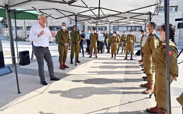 Defense Minister Benny Gantz, left, speaks to IDF soldiers during a visit to the IDF Central Command in Jerusalem, on September 15, 2020. (Ariel Hermoni/Defense Ministry)