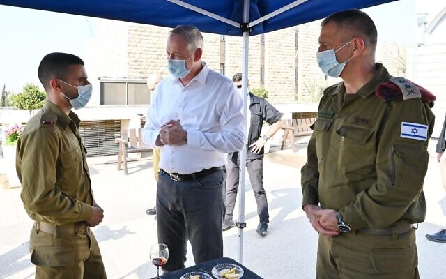 Defense Minister Benny Gantz, center, speaks to an IDF officer as army chief Lt. Gen. Aviv Kohavi, right, watches on during a visit to the IDF Central Command in Jerusalem, on September 15, 2020. (Ariel Hermoni/Defense Ministry)