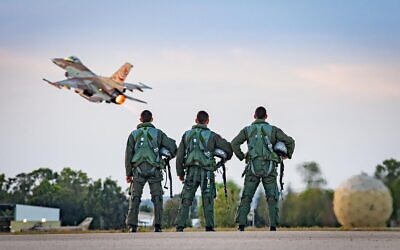Illustrative: Three pilots stand in front of an F-16 fighter jet as it takes off from the Israeli Air Force's 117th Squadron, which was closed on September 30, 2020. (Israel Defense Forces)