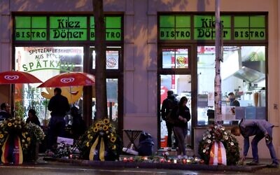 Wreaths and candles are seen in front of a Doner kebab shop in Halle, Germany, on October 9, 2020, on the first anniversary of the anti-Semitic attack on the synagogue. (Ronny Hartmann/AFP)