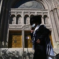 A Hasidic Jew walks past a closed synagogue in the Borough Park section of Brooklyn, one of the five boroughs of New York City, on October 9, 2020.  (Angela Weiss / AFP)