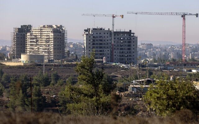 New apartments buildings under construction in the Beit El settlement in the West Bank with the Palestinian city of Ramallah in the background, October 13, 2020. (Menahem Kahana/AFP)