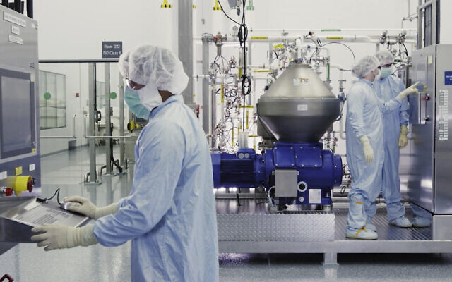 Illustrative: In this undated image from video provided by Regeneron Pharmaceuticals on Friday, October 2, 2020, scientists work with a bioreactor at a company facility in New York state, for efforts on an experimental coronavirus antibody drug. (Regeneron via AP)