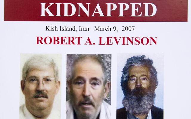 An FBI poster showing a composite image of former FBI agent Robert Levinson, right, of how he would look like now after five years in captivity, and an image, center, taken from the video, released by his kidnappers, and a picture before he was kidnapped, left, displayed during a news conference in Washington, March 6, 2012. (Manuel Balce Ceneta/AP)