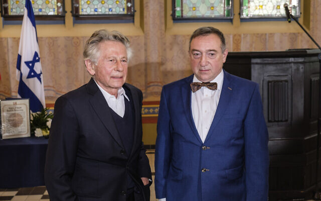 Oscar-winning filmmaker Roman Polanski, left, poses for the media with Stanislaw Buchala, right, who received the Israeli distinction of the Righteous Among the Nations on behalf of his late grandparents, Stefania and Jan Buchala, who saved Polanski, from the Holocaust in 1943-45, during the ceremony of bestowing the honor in Gliwice, Poland, October 15, 2020.(Michal Buksa/AP)