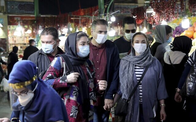People wear protective face masks to help prevent the spread of the coronavirus, in the Tajrish traditional bazaar in northern Tehran, Iran, October 15, 2020. (AP Photo/Ebrahim Noroozi, File)