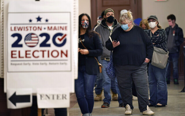 Residents wait to cast their absentee ballots during early voting, Friday, Oct. 30, 2020, in Lewiston, Maine. (AP Photo/Robert F. Bukaty)
