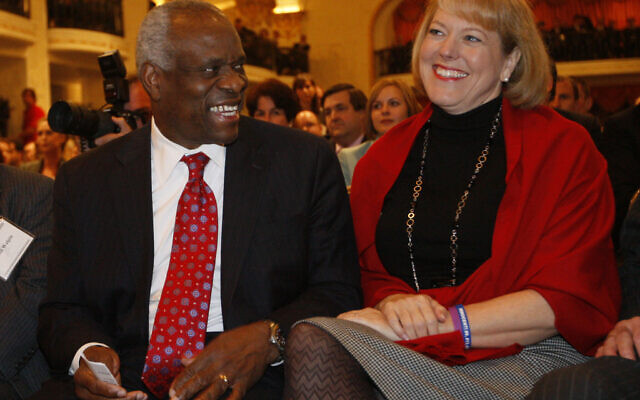 In this Nov. 15, 2007, photo, US Supreme Court Justice Clarence Thomas, left, sits with his wife Virginia Thomas, as he is introduced at the Federalist Society in Washington(AP Photo/Charles Dharapak, File)