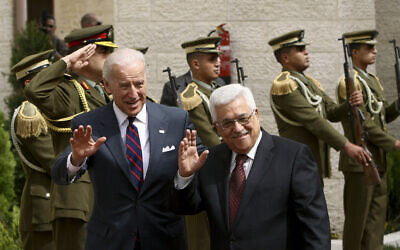 US Vice President Joseph Biden, left, and Palestinian Authority President Mahmoud Abbas wave to the press ahead of their meeting in the West Bank city of Ramallah, March 10, 2010. (AP Photo/Tara Todras-Whitehill)