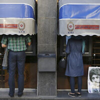 Illustrative: Iranians use ATMs of Bank Melli Iran in downtown Tehran, Iran, April 4, 2015. (AP Photo/Vahid Salemi, File)