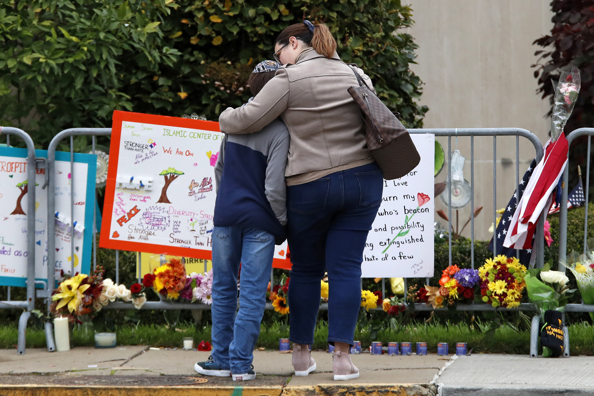 A mother hugs her son in front of a memorial at the Tree of Life synagogue in Pittsburgh on October 27, 2019. (AP/Gene J. Puskar/File)